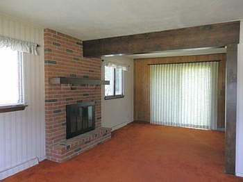 A fireplace in this grand living room