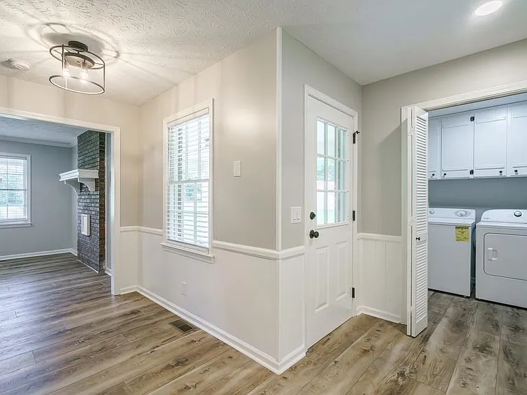 View from kitchen into living room and laundry room/pantry area