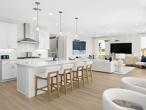 Open gathering area with view of kitchen