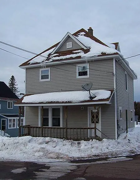 House is on the corner of two streets. Has two entry doors.