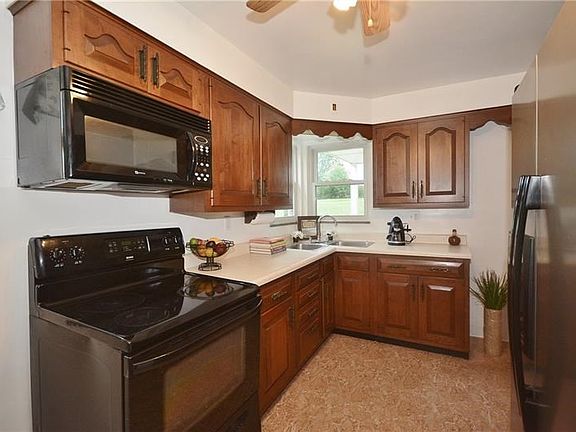 Stainless steel fridge and black appliances give a nice sleek look to this kitchen.