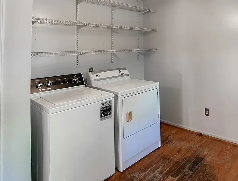 Large laundry room accessible from kitchen with separate mud entrance and ample wire shelves. Washer and dryer included.