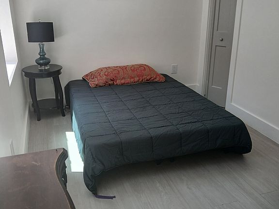 Bedroom with closet to right of bed