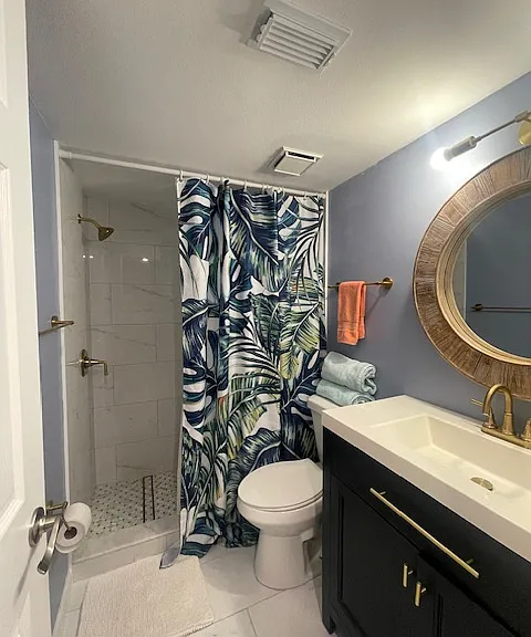 newly tiled bathroom, new credenza and brass fixtures