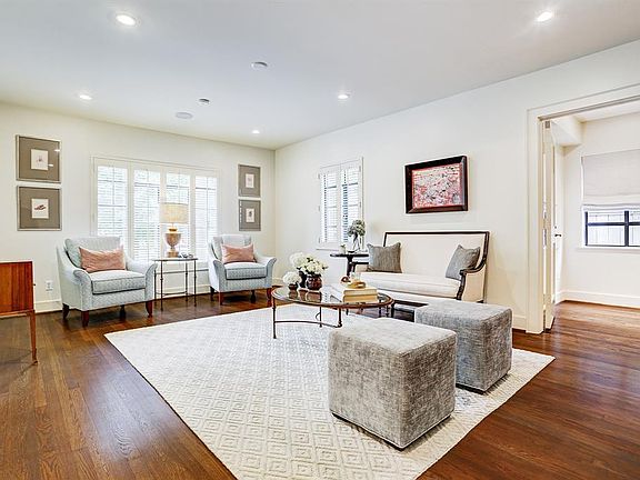 The formal living room is filled with natural light and overlooks the front yard. It is quite spacious and offers access to various rooms. Here you can see the convenient doorway into the study/office.