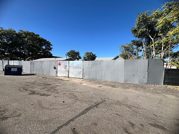 Main entrance gate view from street showing both entrance