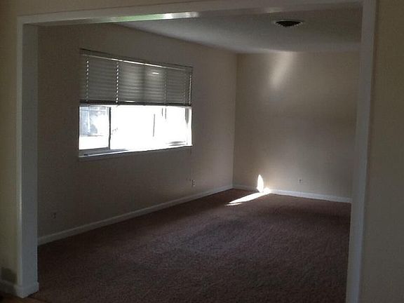 Spacious living room looks out to back yard