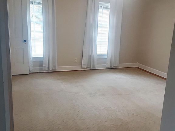 Living room with walk in closet Ceiling fan, natural light 3 windows