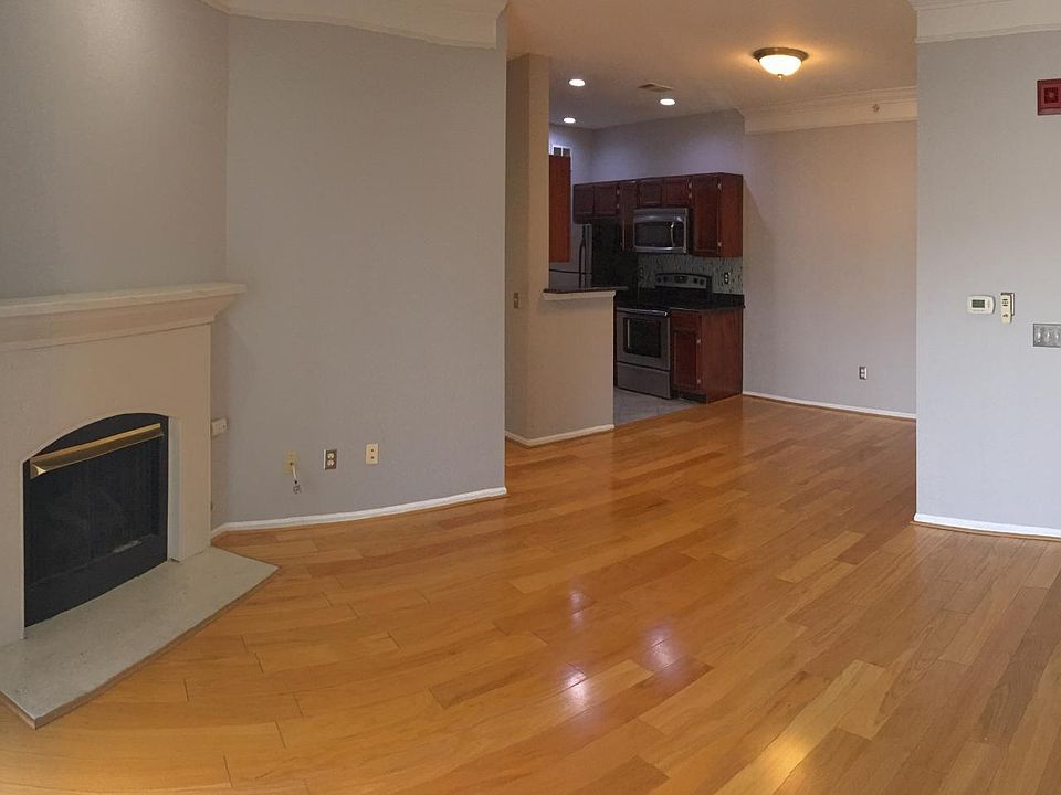 panoramic view of living room, dining room into kitchen, and front entrance