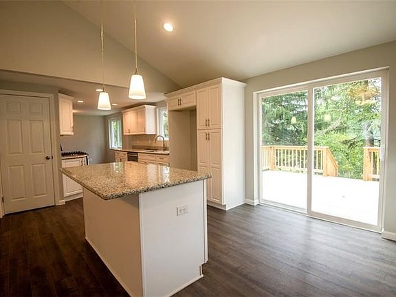 Custom kitchen with granite counter tops, stainless steel appliances, soft close doors and drawers and island with seating for t