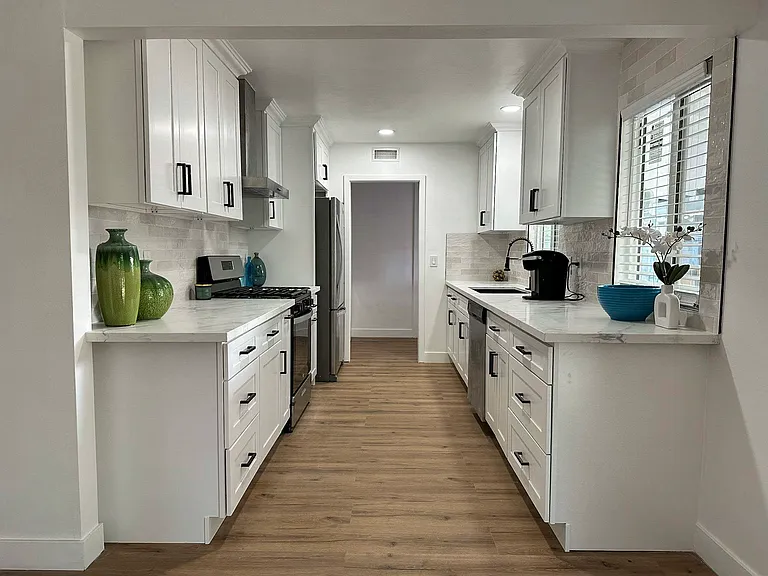 Kitchen comes with Keurig coffee machine, toaster, oven, gas stovetop with 4 burners, and plenty of natural light.