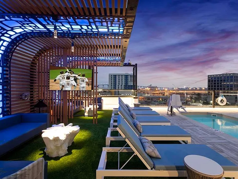 Unique lighting features under the shade structures transform the rooftop pool deck into an evening lounge that offers sparking views of San Diego and the bay beyond