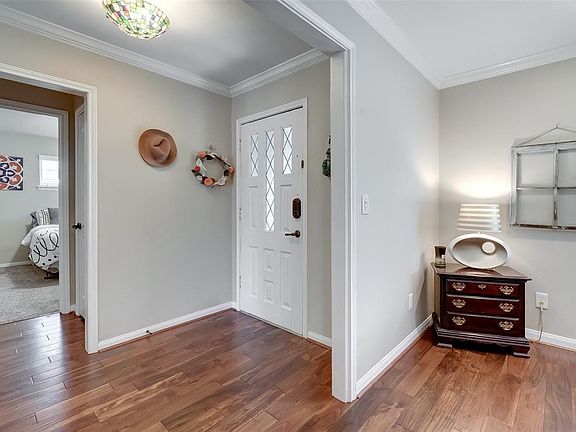 The Entryway is Open to the Hallway of Bedrooms to the Right, the Den Straight Ahead, and the Formal Living and Dining to your left.