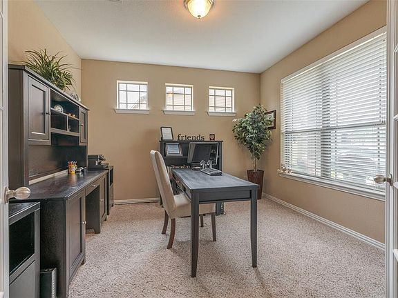 French doors lead you into the spacious office.