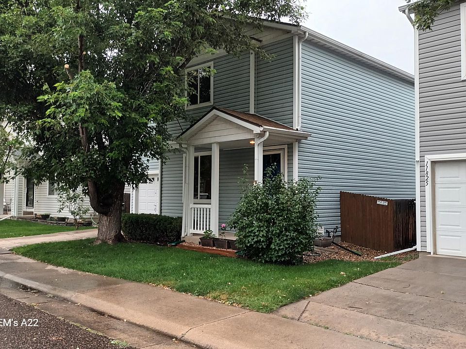 Front view of home with large maple tree.