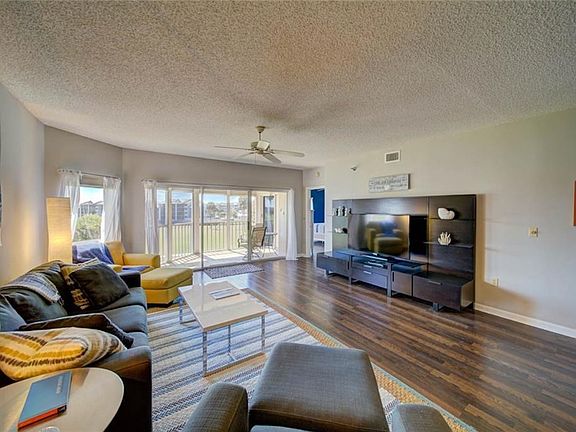 Living Room Leading To Balcony Overlooking Golf Course and Lake