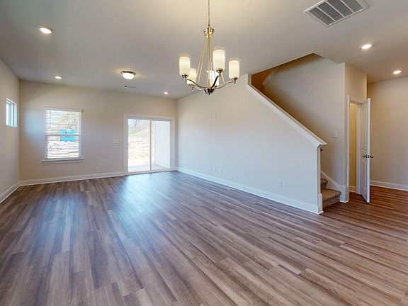 The open-concept floorplan allows an easy flow from the kitchen to the living and dining areas.