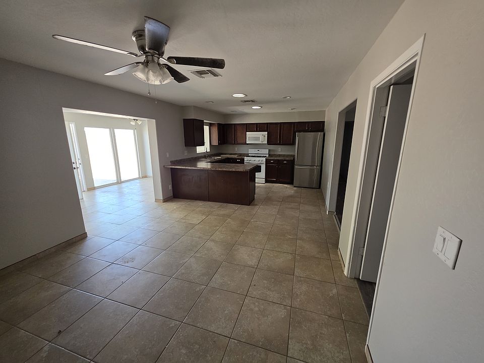 Kitchen and dining area. Sun room is seen where the large glass windows are.