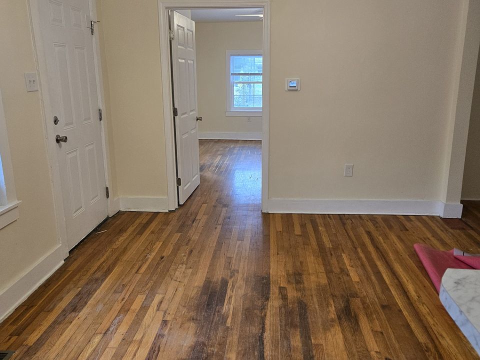 Family room with ceiling fan, new steel exterior doors, hardwood floors, new double pane windows