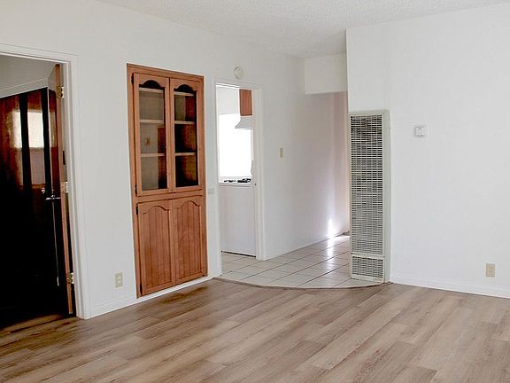 New floors are light, bright in this living room. Very large room, multiple use: living room, study or formal dining.