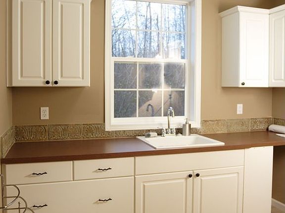Large mud/laundry room with views to the side yard