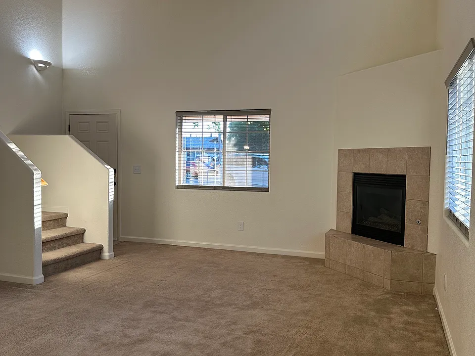 Living room with view of the stair entrance