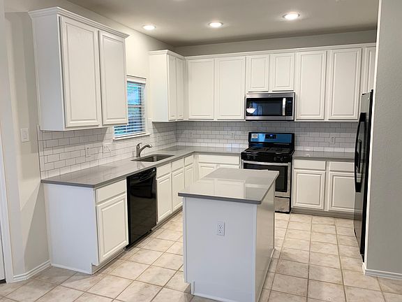 Newly remodeled kitchen with quartz countertop, undercount sink, new microwave and new oven.