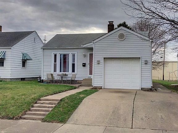 Vinyl sided home with single car garage