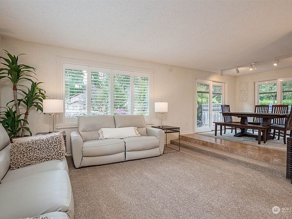 Bright living room with classy wooden adjustable shutters>