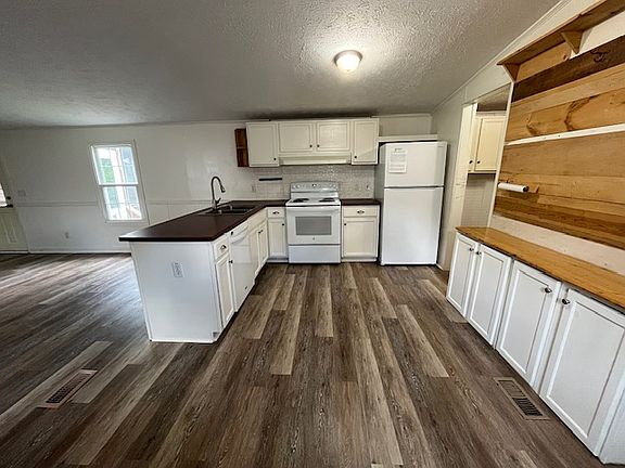 Laundry room and additional storage space to the right of kitchen.