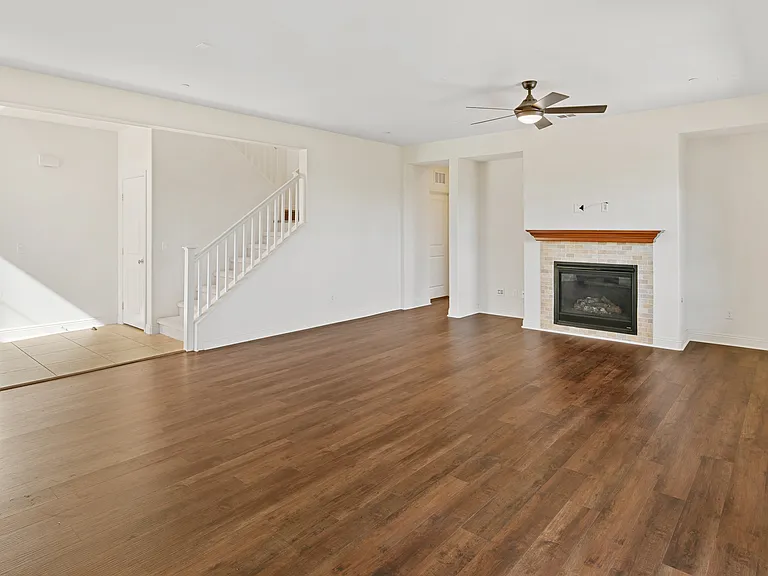 Formal Family Room with Fireplace and Hardwood Flooring and Fan