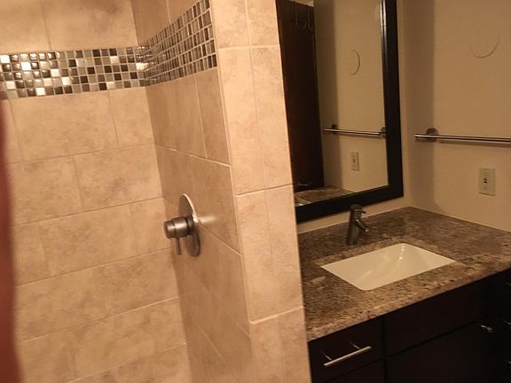 updated bathroom with tile surrounds, and granite counter top