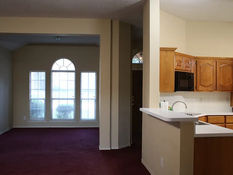 From back door, viewing across living room to connected dining room