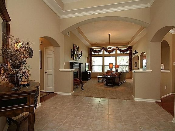 View from the front foyer looking into the Family Room.  Note the high tray ceilings and arched openings.