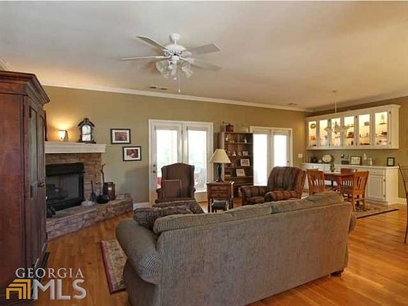 Welcoming great room with corner stone fireplace!