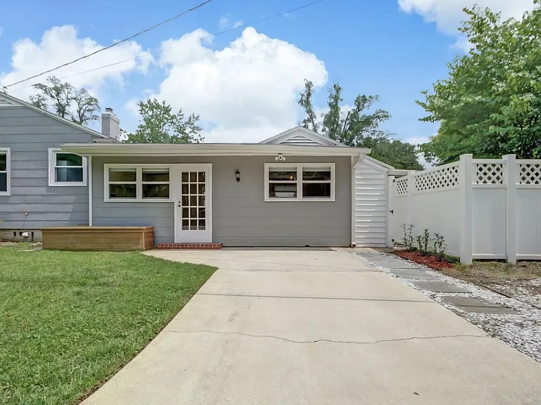 Primary parking spots along the side of the house with a convenient side door for entry with a key pad. Additional gravel parking spot to the right