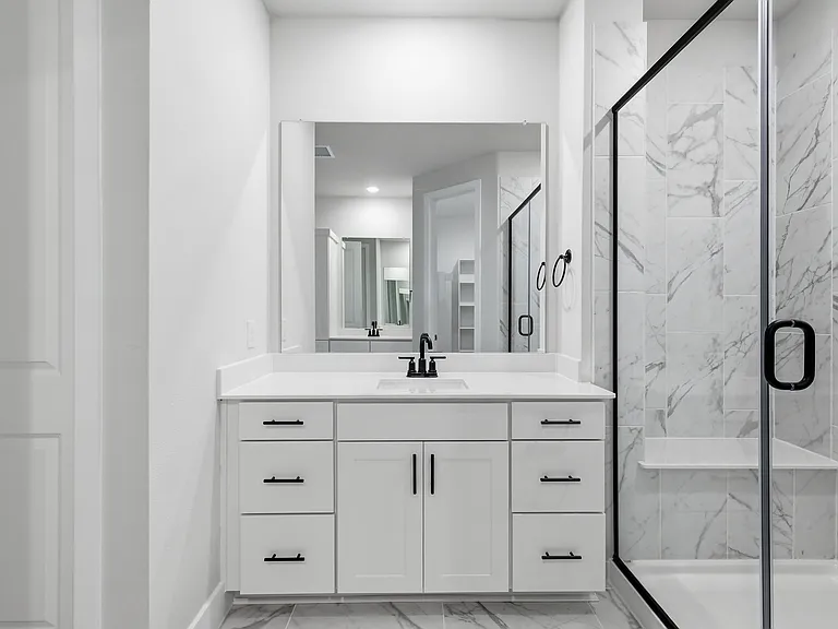 Primary bathroom with separate vanities and a huge walk-in closet