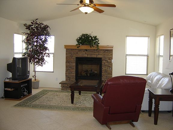Family room adjoins the kitchen and features a fireplace, vaulted ceiling.