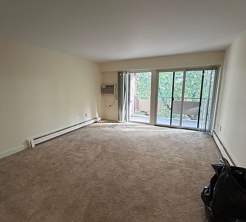 Nice sized living room with all new carpeting, opens up to private balcony.