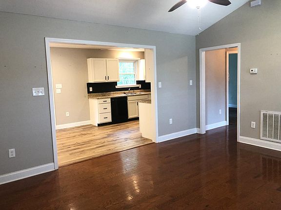 front door opens into the living room, that is open to the kitchen.