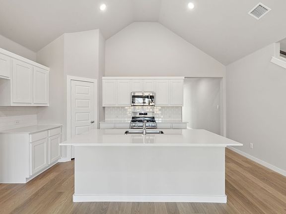 Kitchen in the Claret home plan by Trophy Signature Homes - REPRESENTATIVE PHOTO