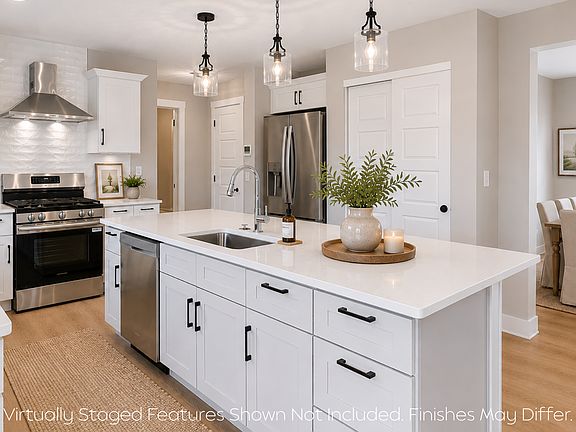 Open-concept kitchen with abundant workspace, granite countertops, island, Shaker cabinetry and more