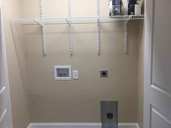 Washer/Dryer hook ups in a well lit closet near the kitchen