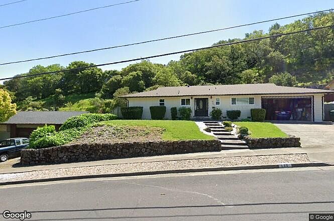 The front of the house (ranch style) has a walkup and driveway. Yardwork is ongoing. The home is nestled next to the hillside providing good privacy. There is a large pool and sizable patio for parties or quite time as the afternoon breeze and wildlife