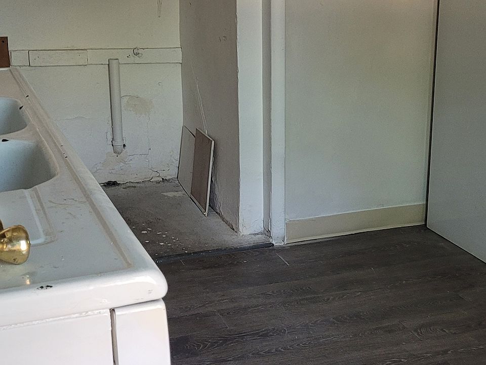 Kitchen with a washer/dryer hookup, gas stove and refrigerator