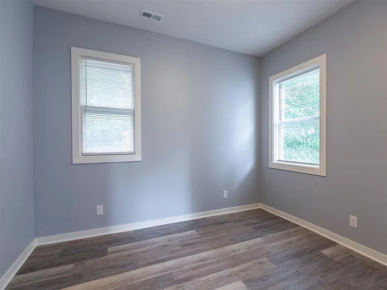 Wood flooring and white trim in a bedroom at Park Avenue Apartments.