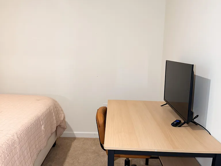 Private bedroom setup with a bed, work desk and chair, plus a TV for relaxing and streaming.