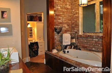 Master Bathroon
						:
						Tub set in 1920's Antique Brick(torn down from Goddard Hotel) & Walnut Beams