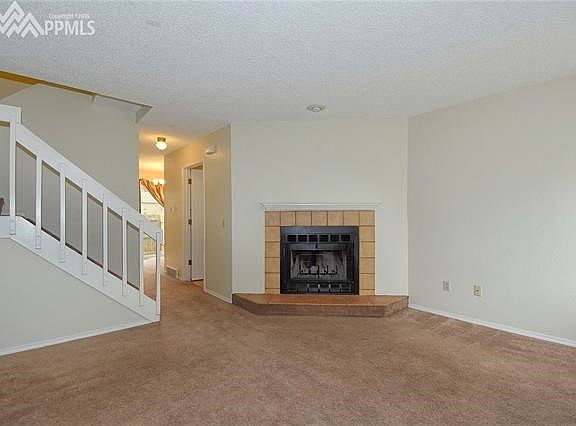 Welcoming Living Room with Wood Burning Fireplace