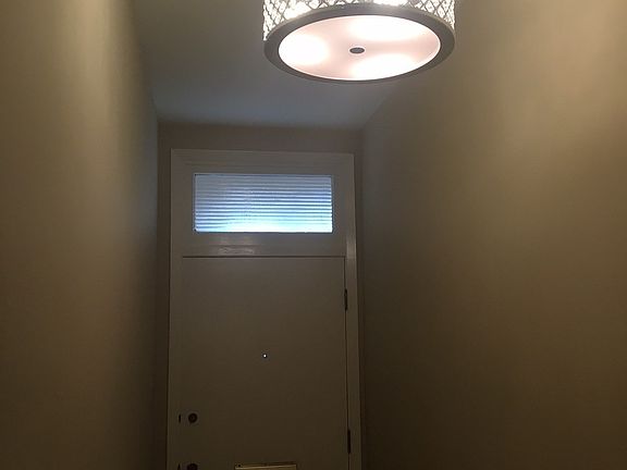 Elegant entry into your flat with modern chandelier.